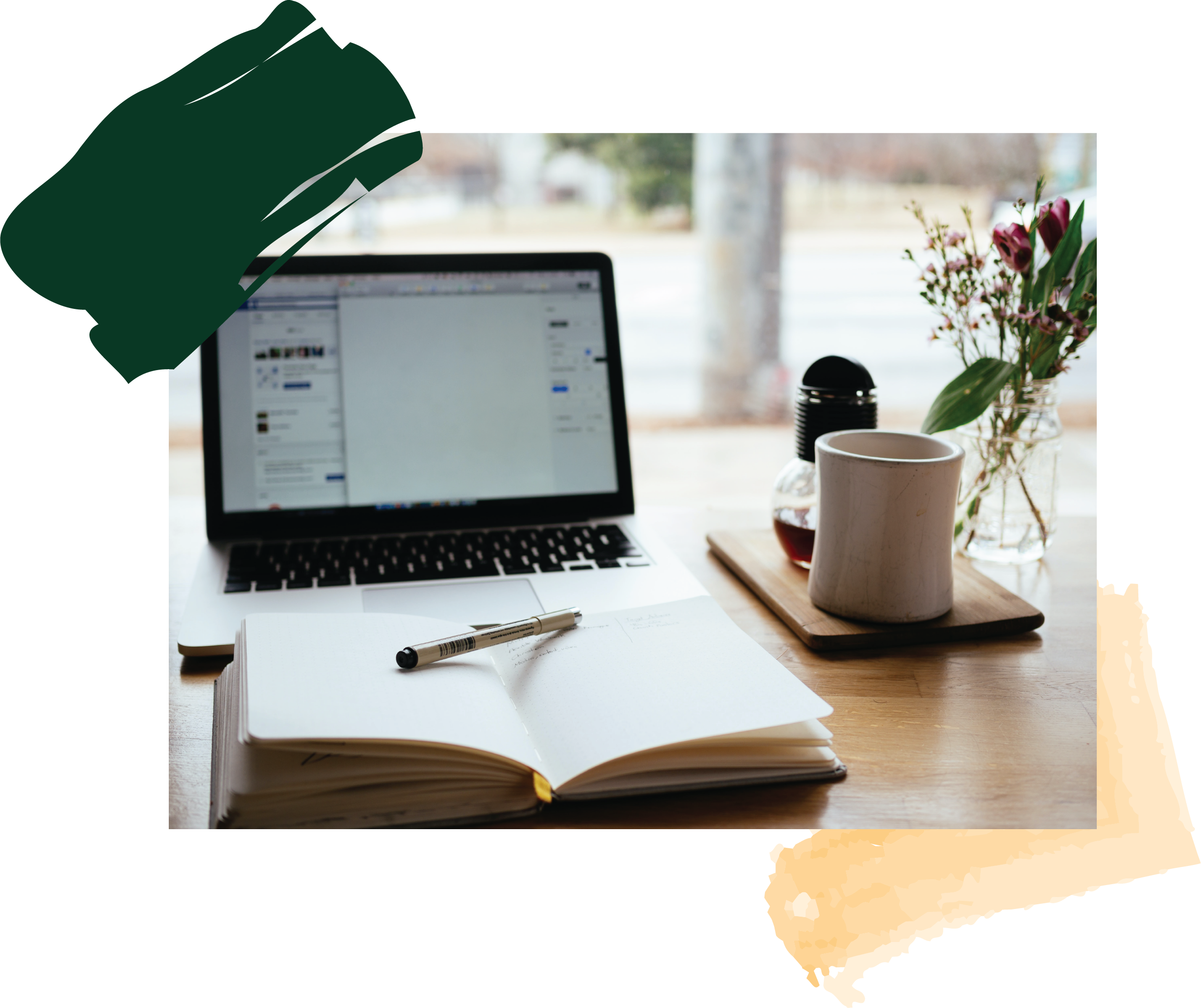 Laptop and notebook on a desk